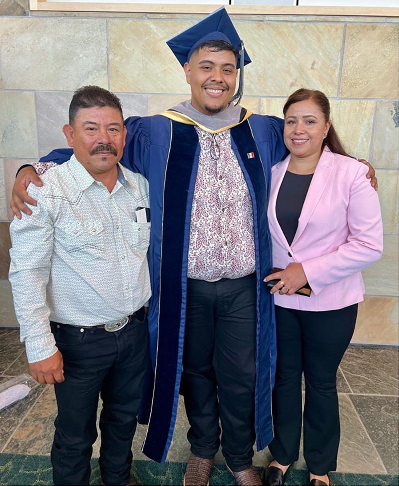 Dr. Adrian Santoyo stands with his parents after the graduation ceremony.