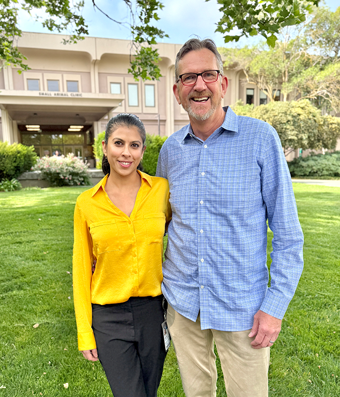 Drs. Anjali Daryani and Jim Clark standing in front of the Small Animal Hospital.