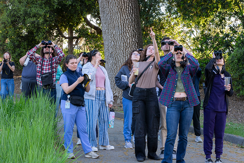 A group of students birdwatching.